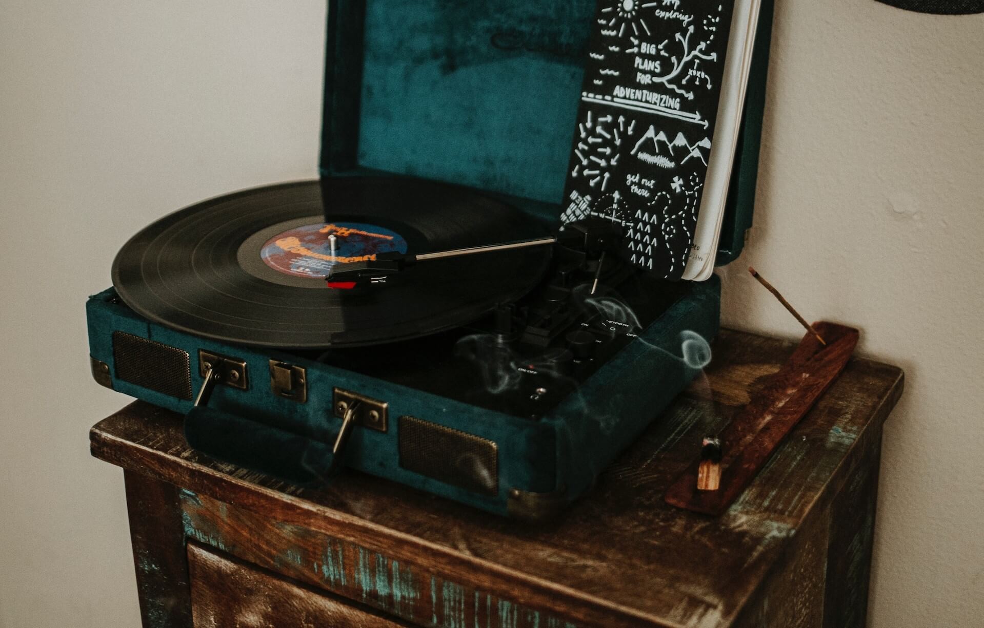 Vintage vinyl player placed on a retro-styled table.